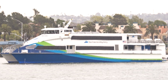 A side view of the MV Lyra, a passenger ferry in the San Francisco Bay Ferry fleet. It has a blue, green and white paint job and the San Francisco Bay Ferry logo is on the side.