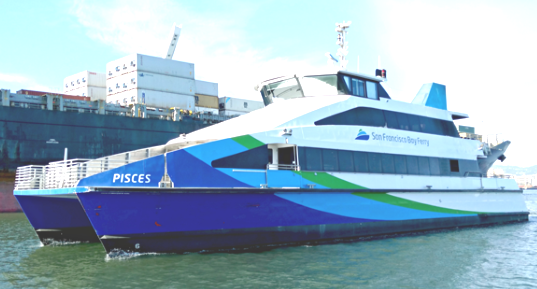 The MV Pisces ferryboat floats atop the water. It has two passenger decks and a blue, green and white paint job. The San Francisco Bay Ferry logo adorns the side.